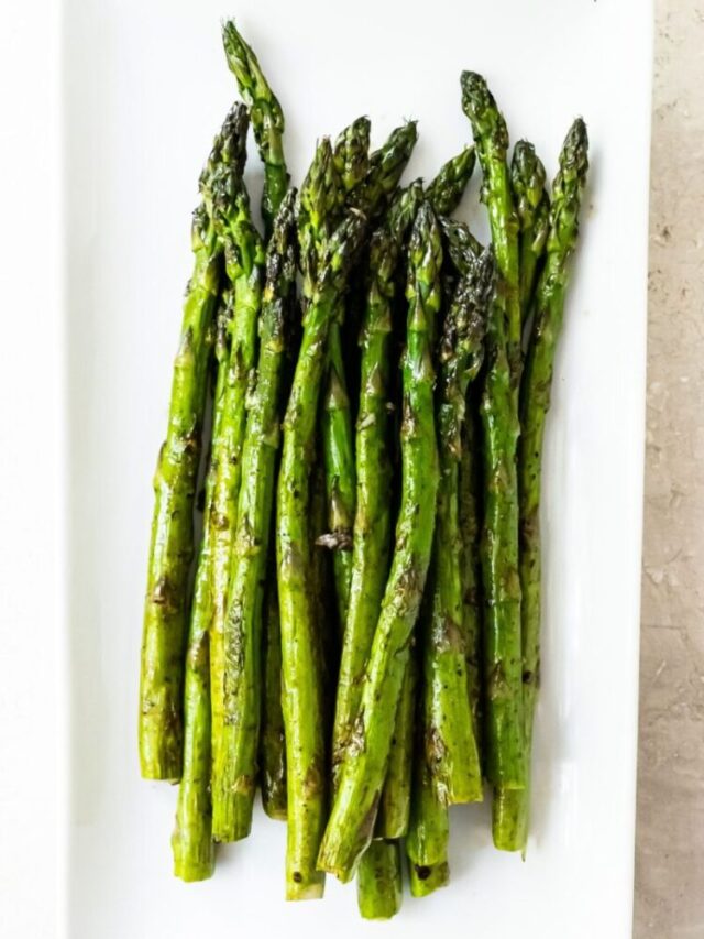 Grilled asparagus on a white plate