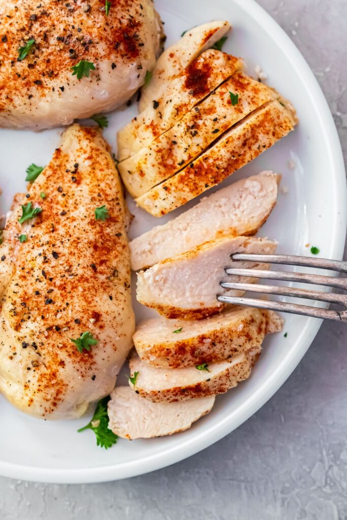 close up image of air fryer small chicken breast once sliced with a fork