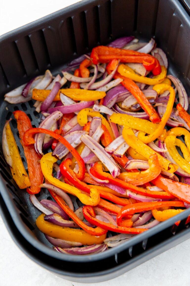 Air Fryer Peppers and Onions in an air fryer basket.