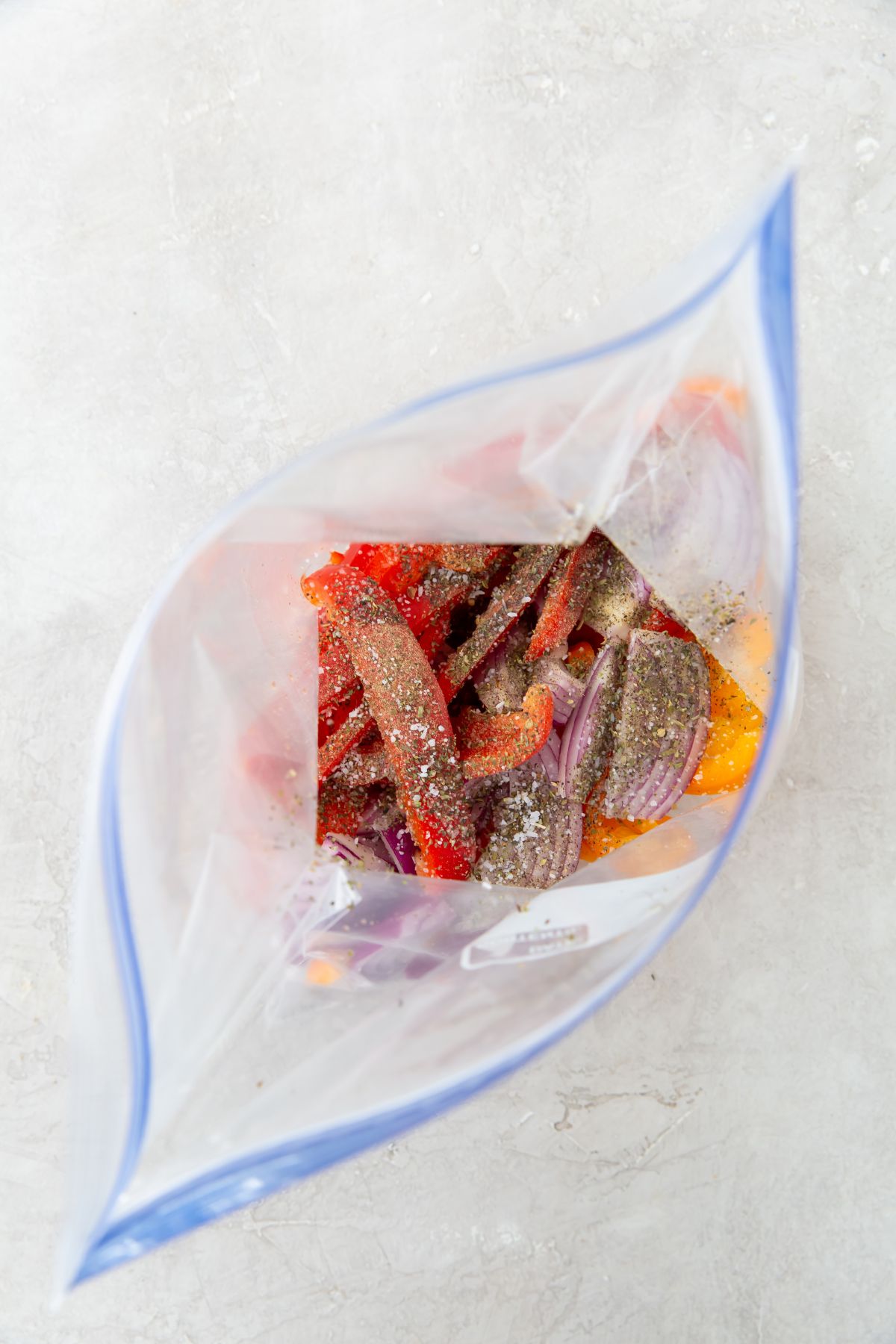 peppers and onions with seasonings in a bag