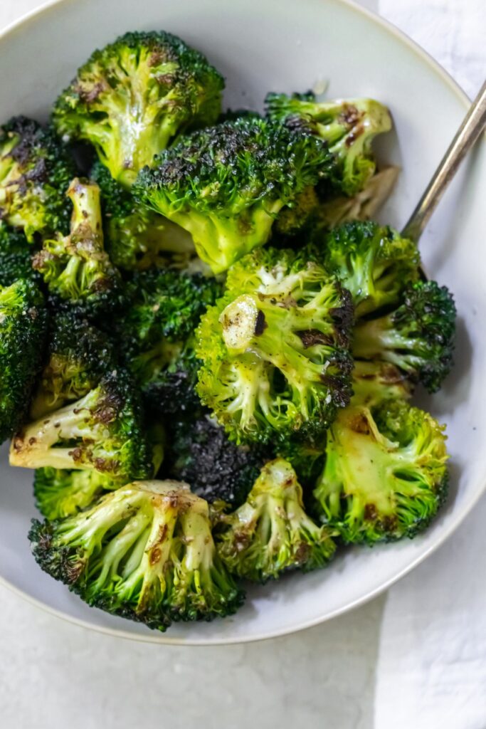 Cooked broccoli in a white bowl