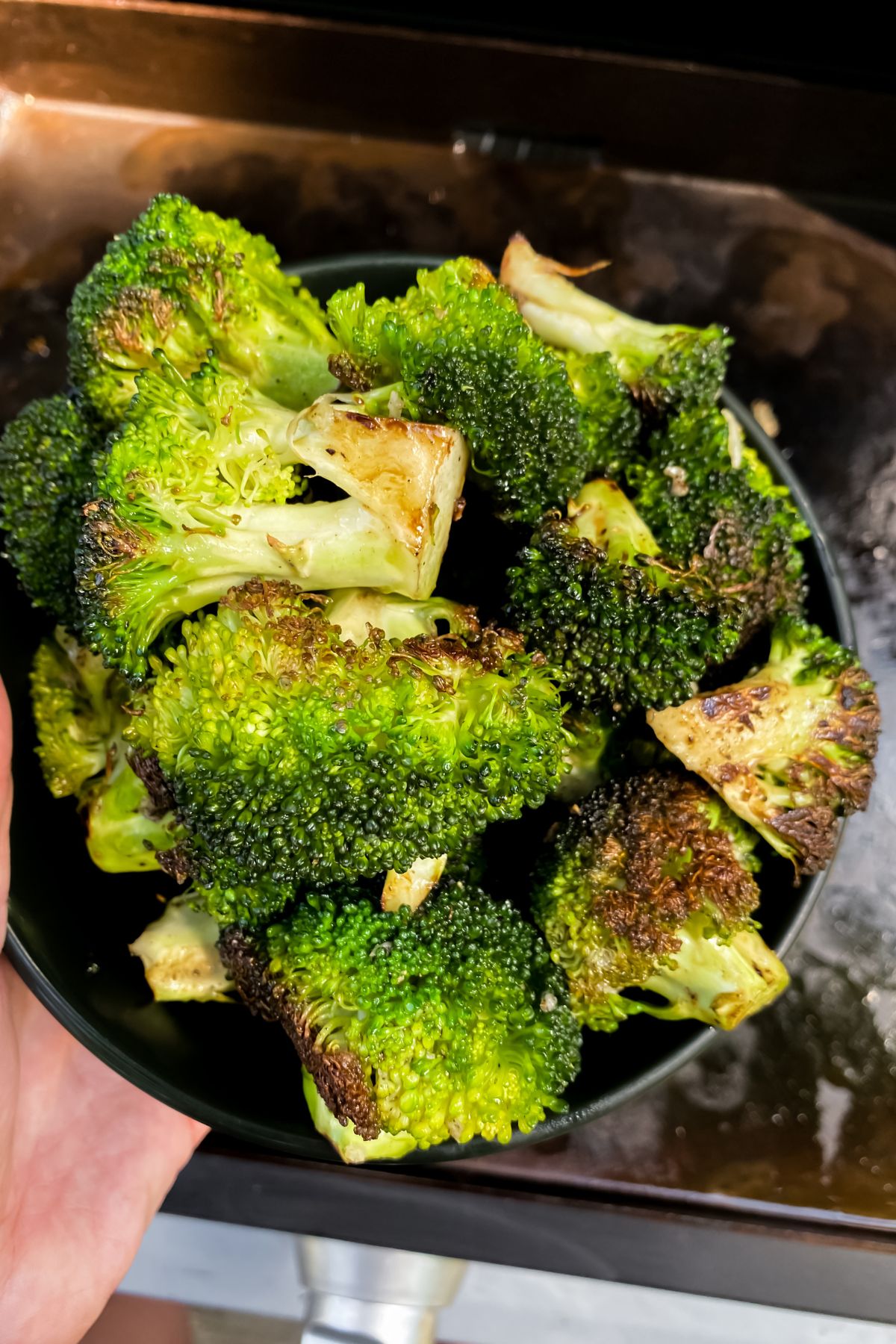 cooked broccoli in a black bowl
