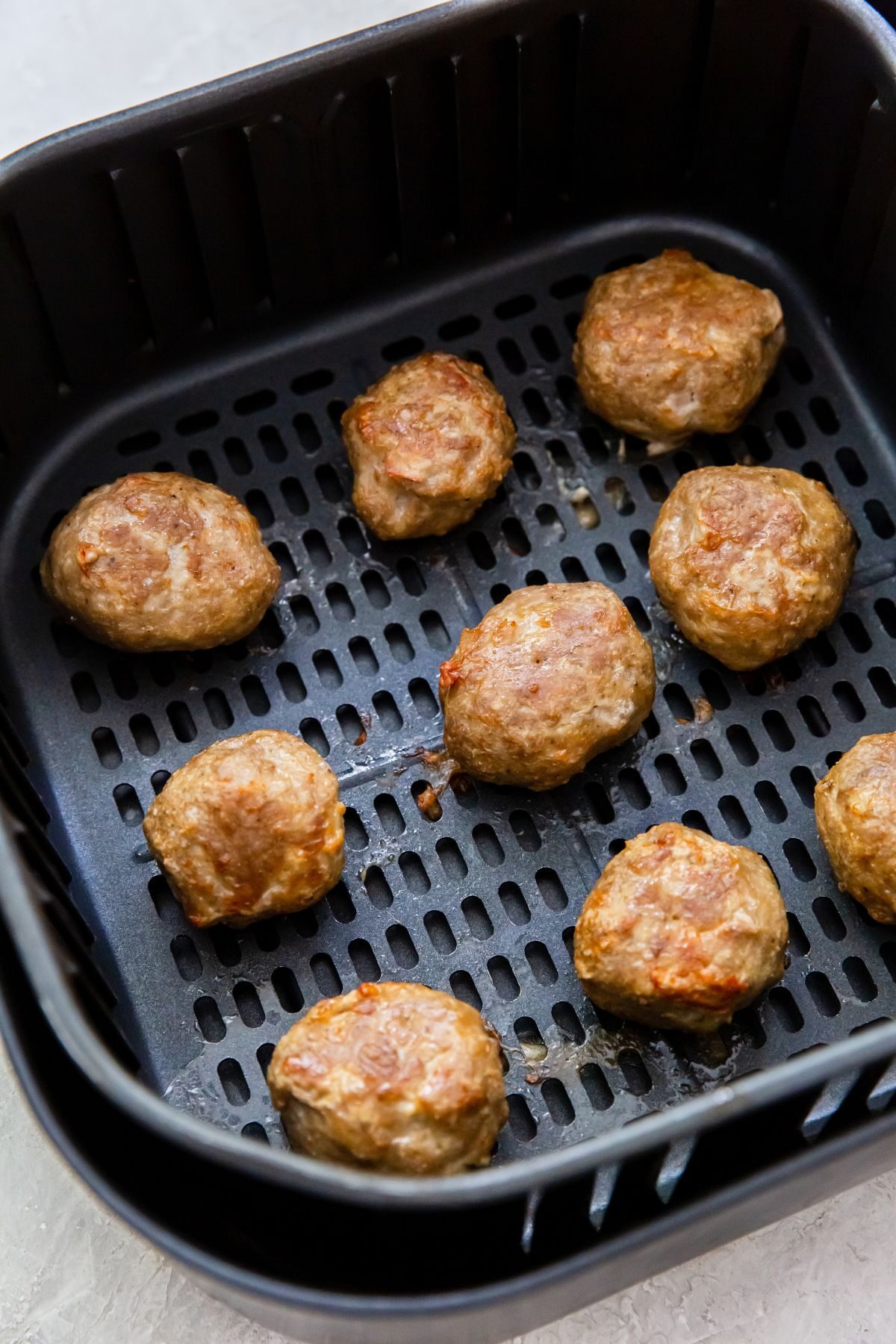 Cooked frozen meatball in the air fryer basket