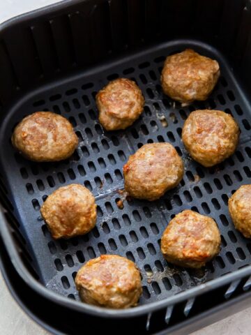 Cooked frozen meatball in the air fryer basket
