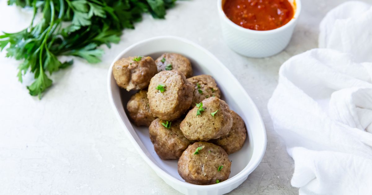 cooked oven turkey meatballs on a white casserole dish
