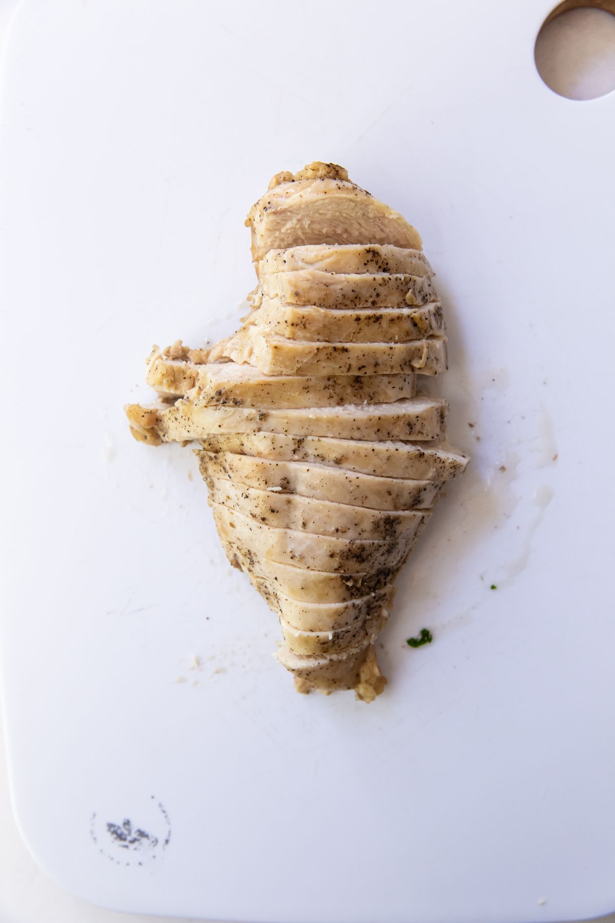chicken breast cut up on a cutting board