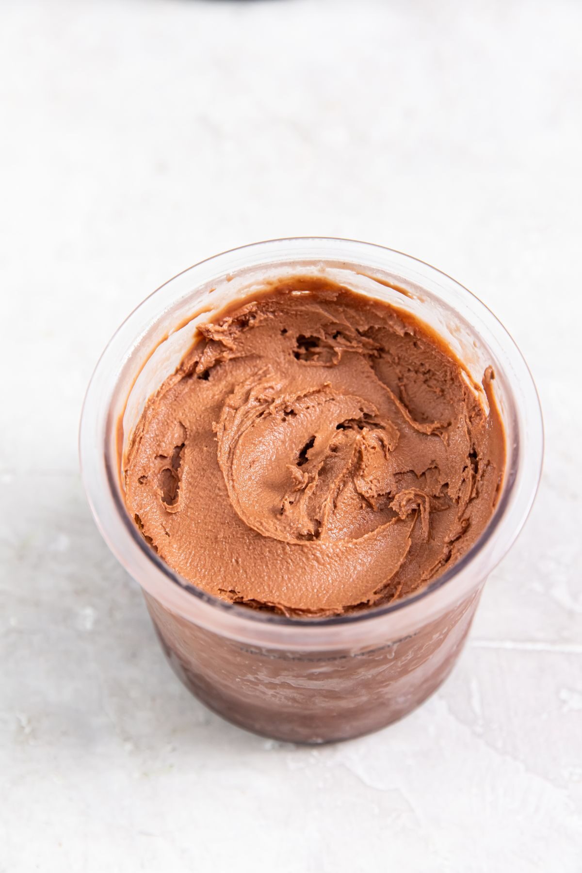 a pint of keto chocolate protein ice cream in a clear pint container