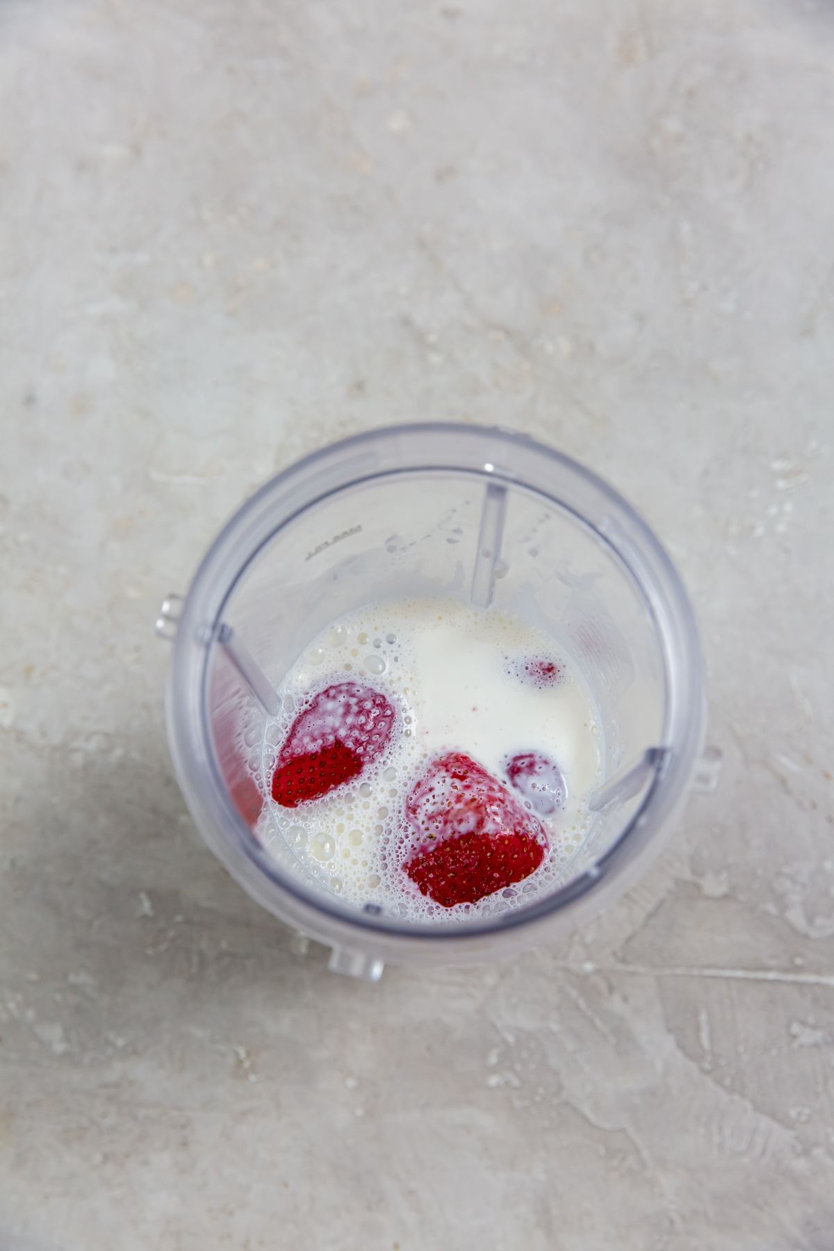 strawberries and heavy cream in a plastic cup