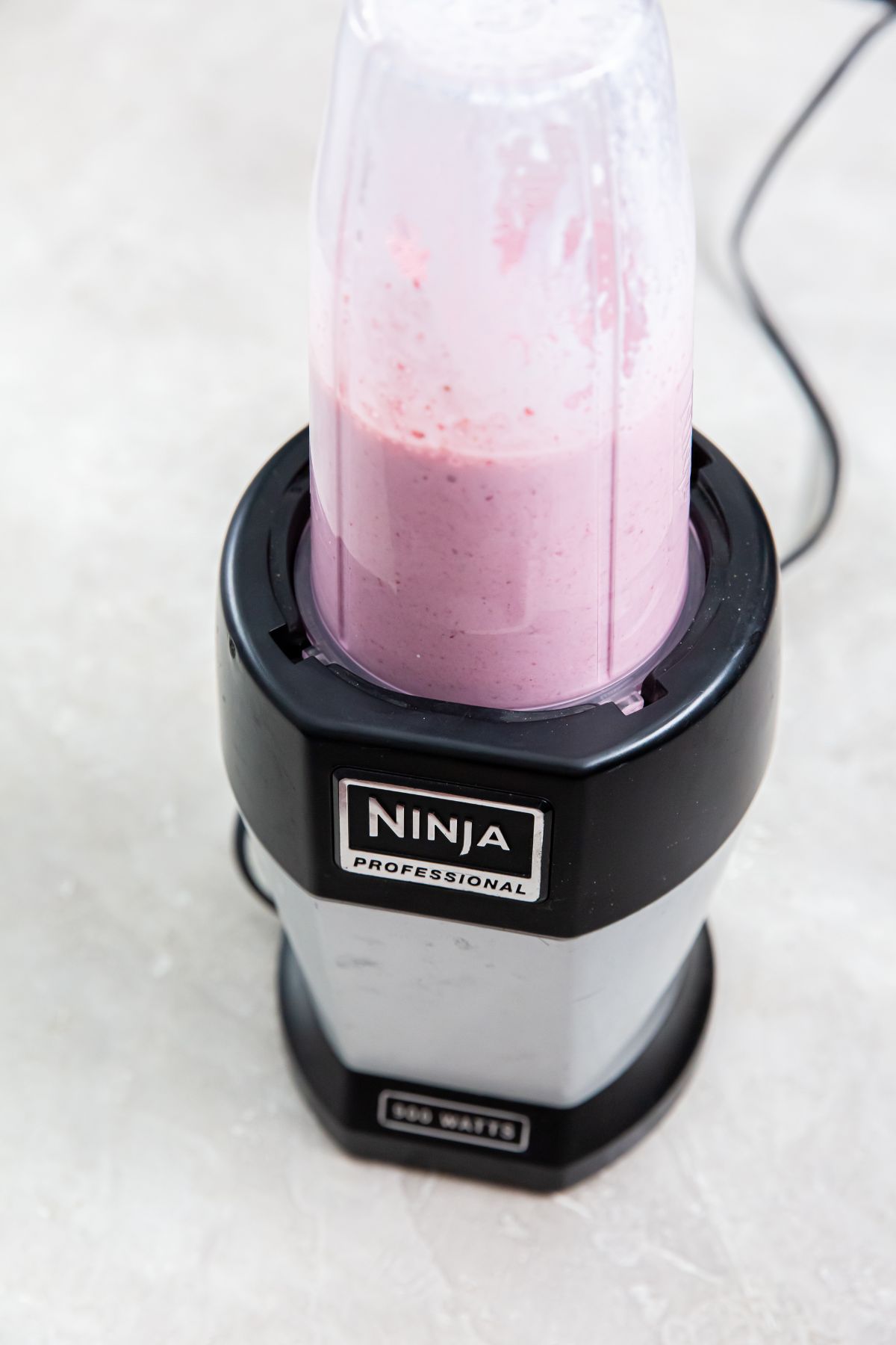 ninja blender with strawberry ice cream in it