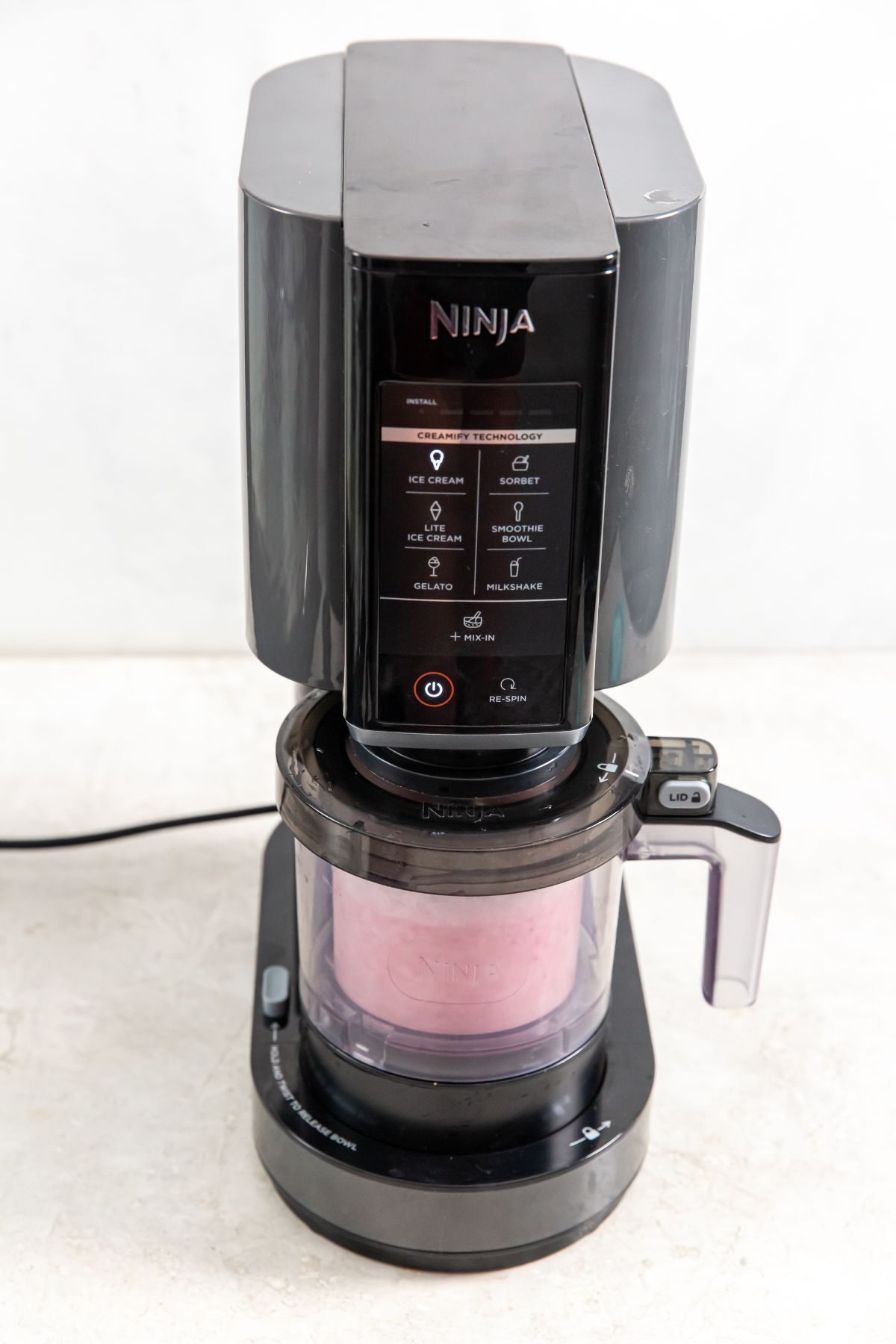 ninja creami ice cream being blended in a ninja creami ice cream maker
