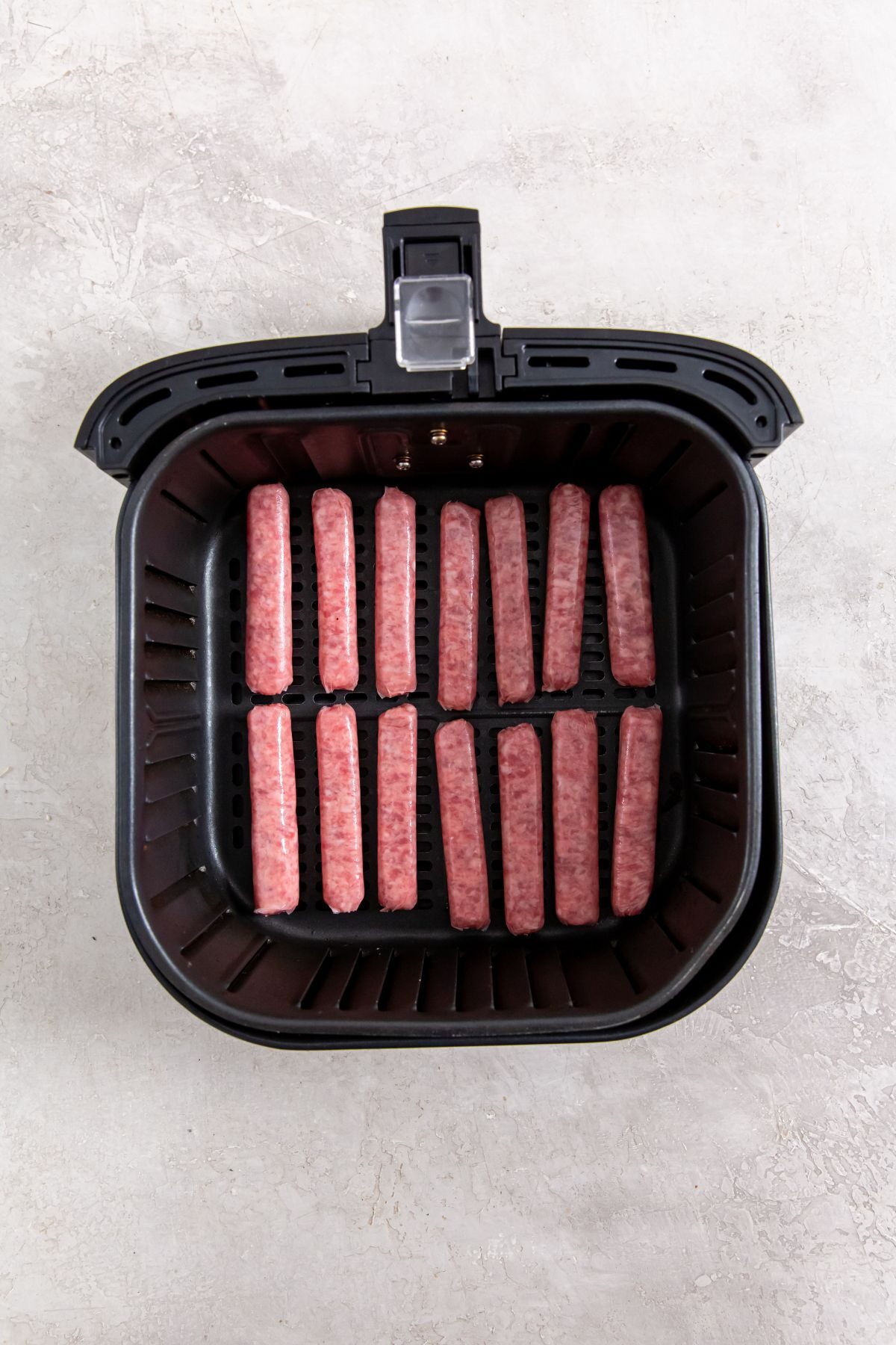 raw sausage links in the air fryer basket