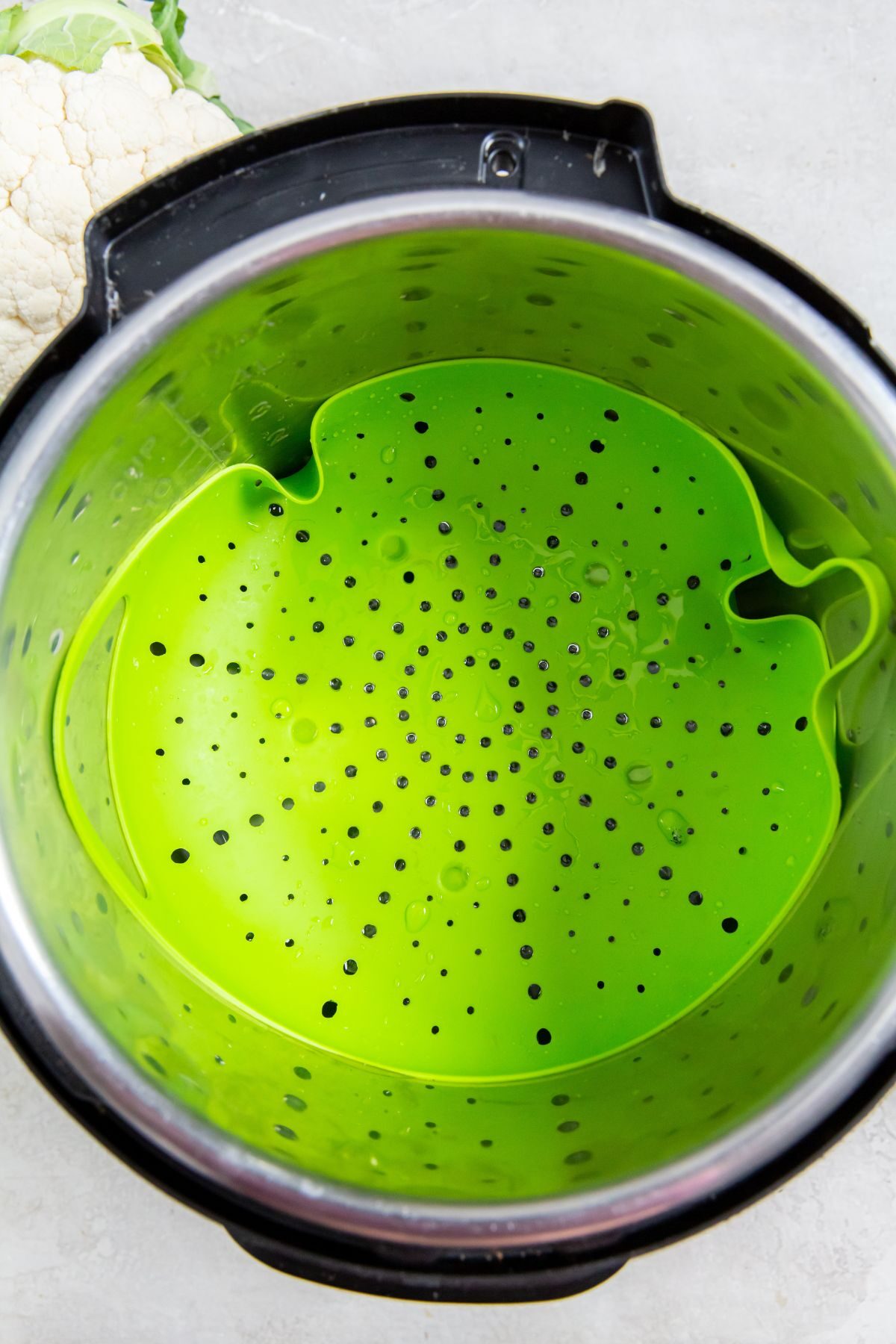 instant pot with a a green trivet.