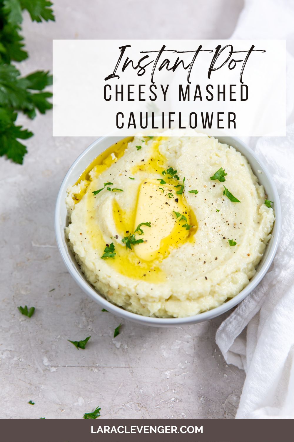pin of Instant Pot Cheesy Mashed Potatoes in a white bowl with a white napkin.