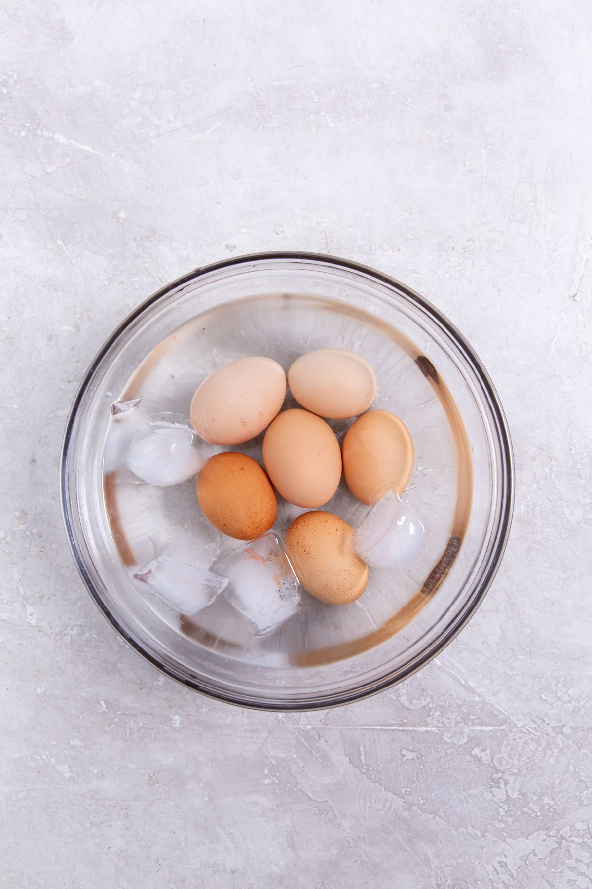 Instant Pot Eggs 5-5-5 Method in a clear bowl with ice