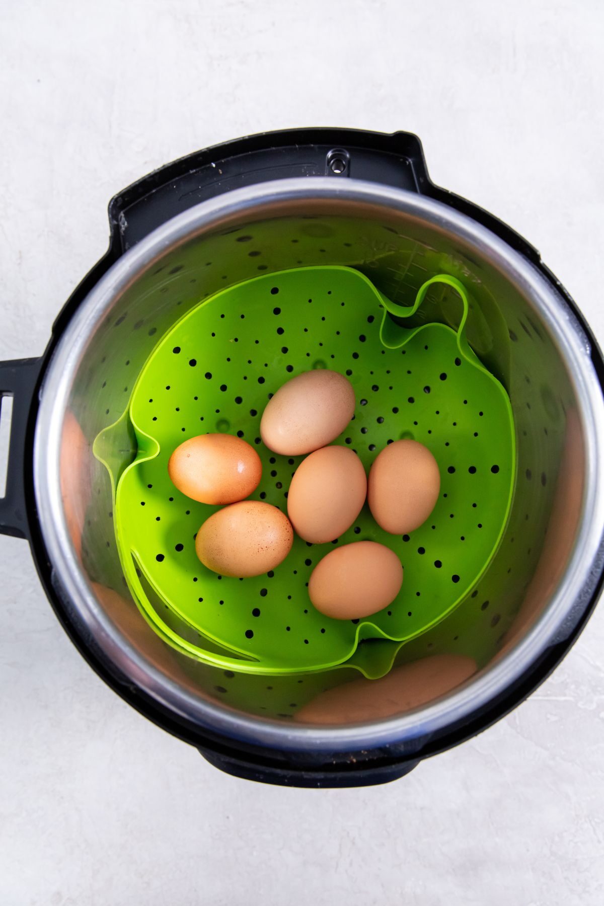 trivet in the instant pot with eggs on it.