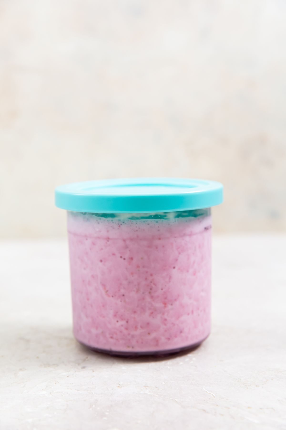 keto strawberry ice cream base in a pint container
