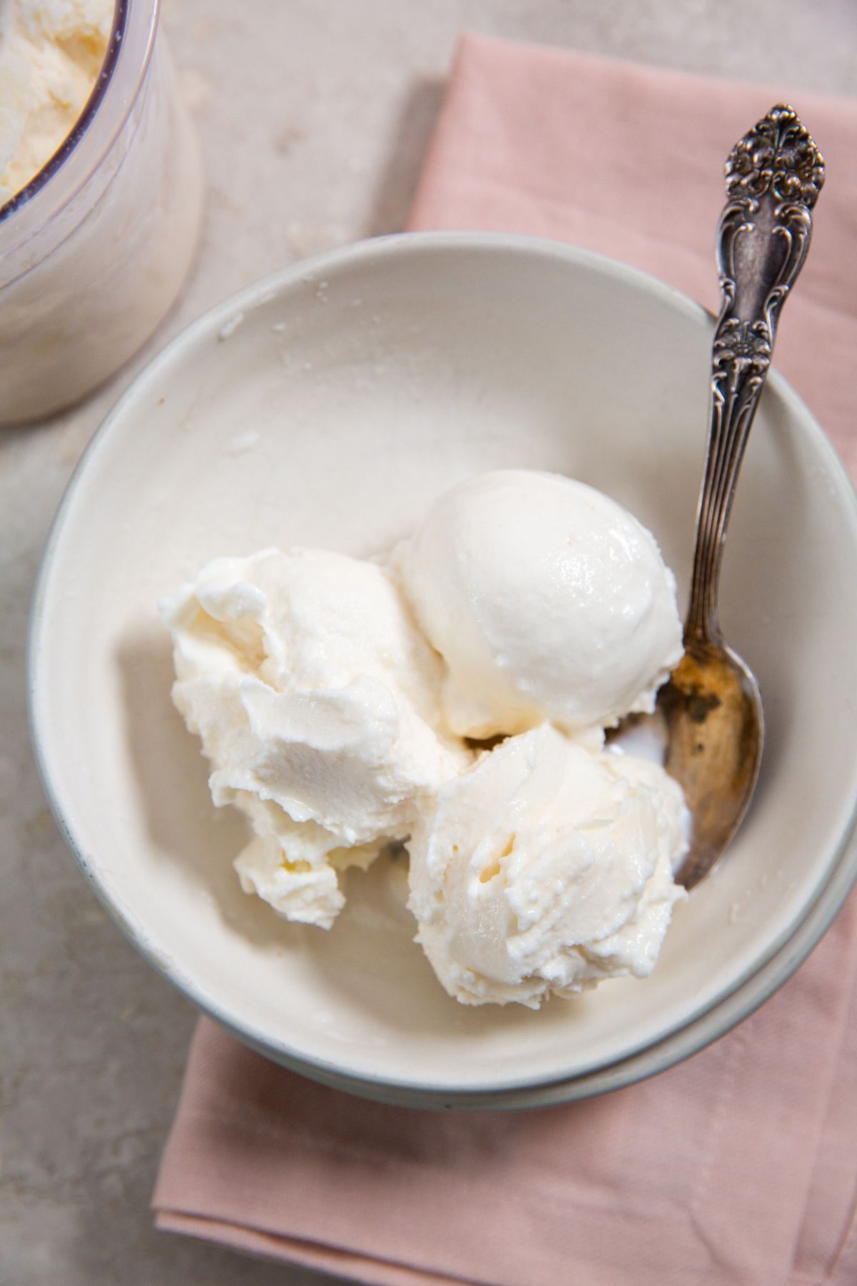 Ninja Creami Vanilla Ice Cream in a white bowl with a spoon and pink napkin