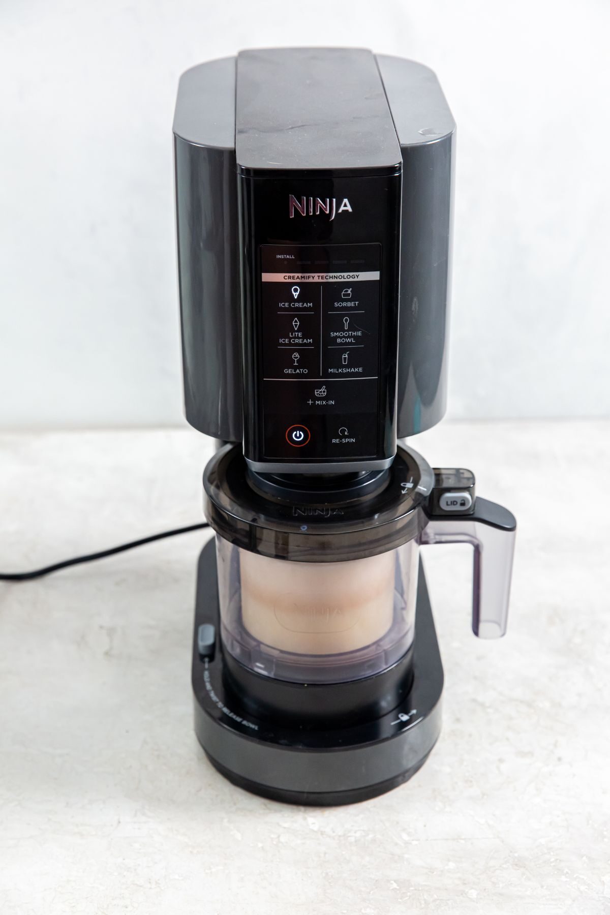 Ninja Creami with peanut butter ice cream in the mixer