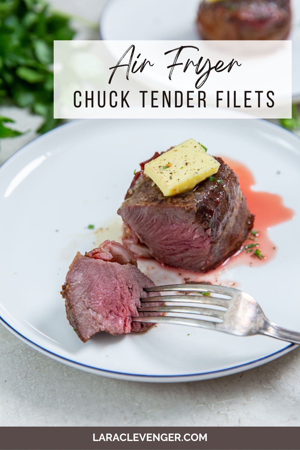 pin of air fryer chuck filets with butter on top with a fork in a piece on the side