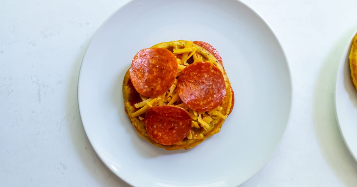 One pepperoni chaffle on a white plate.