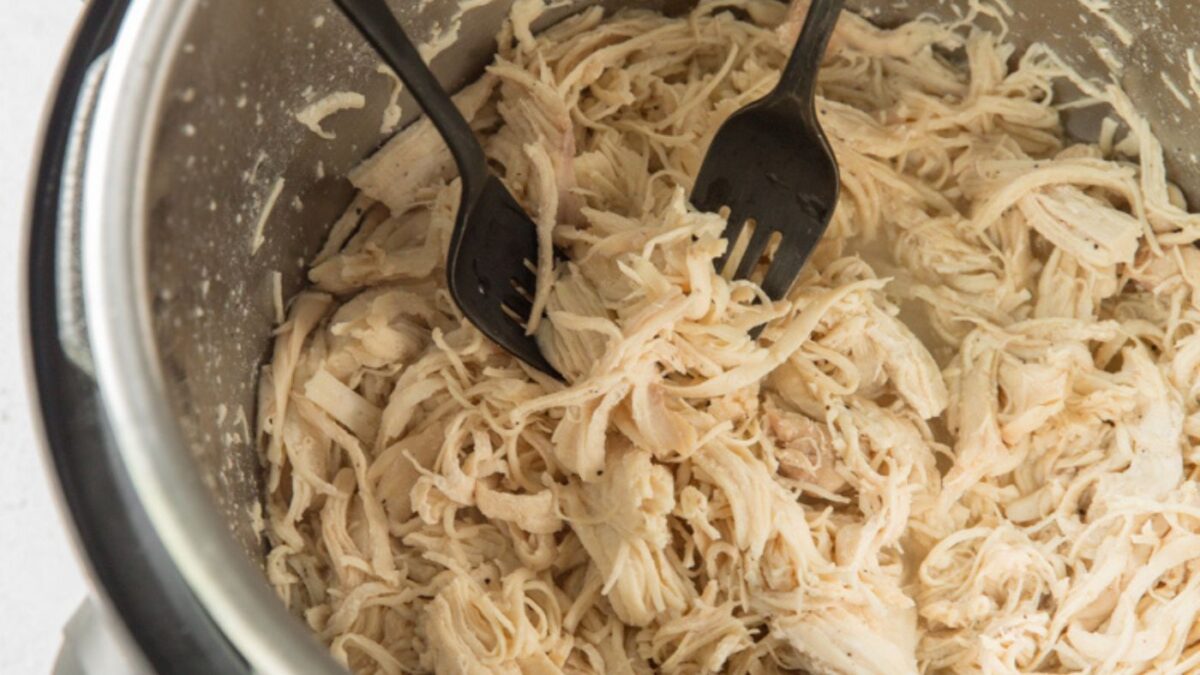 instant pot shredded chicken breast in an Instant Pot with 2 forks.