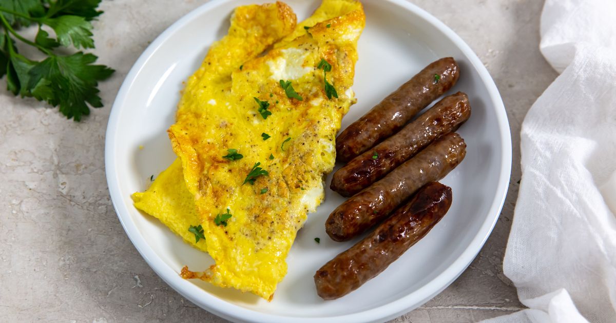 air fryer scrambled eggs with a side of breakfast sausage