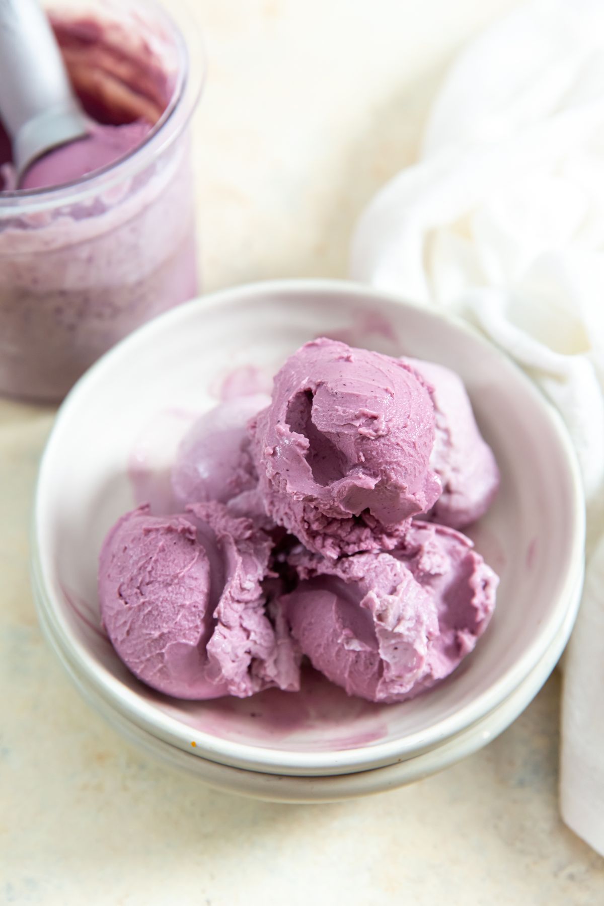 ninja creami low carb blueberry frozen yogurt in a bowl with white napkin