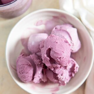ninja creami low carb blueberry frozen yogurt in a bowl with white napkin