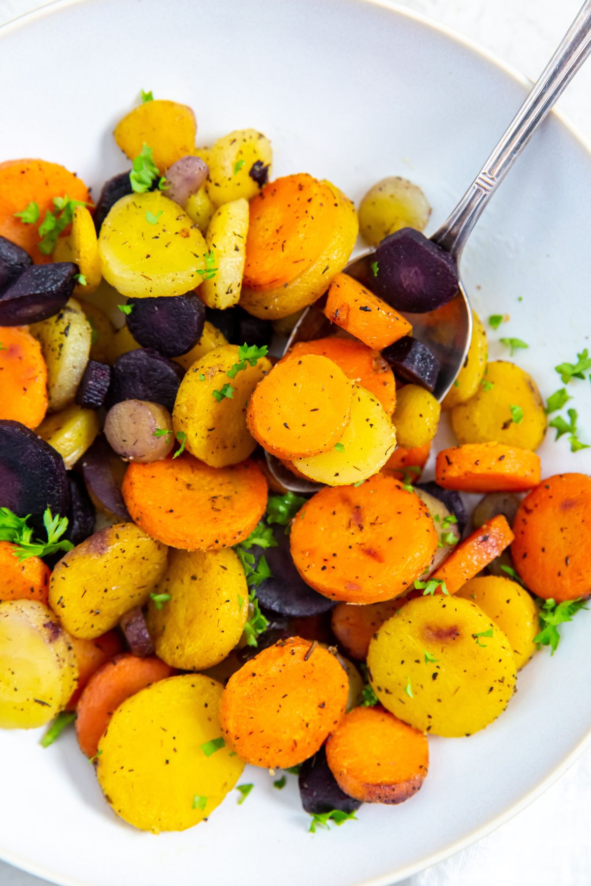 Air fryer Frozen Carrots in a white bowl with a fork in it