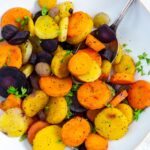 Air fryer Frozen Carrots in a white bowl with a fork in it and a white napkin on the side