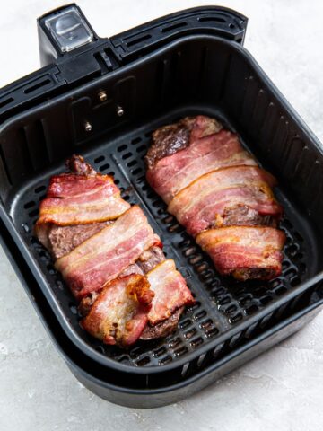 Bacon Wrapped Ribeye Steak in the air fryer basket