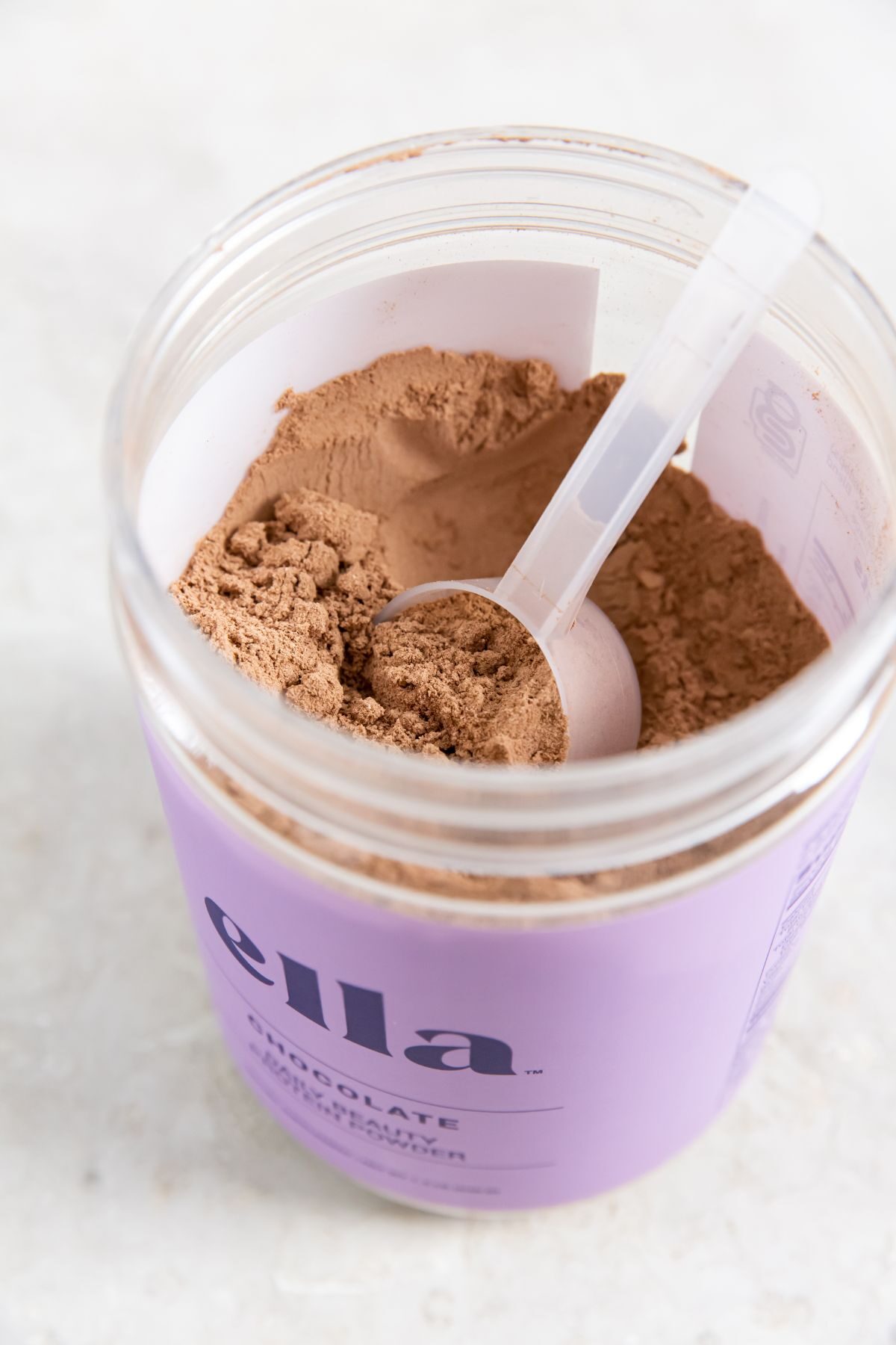 Tub of naked nutrition's Ella daily beauty protein powder.