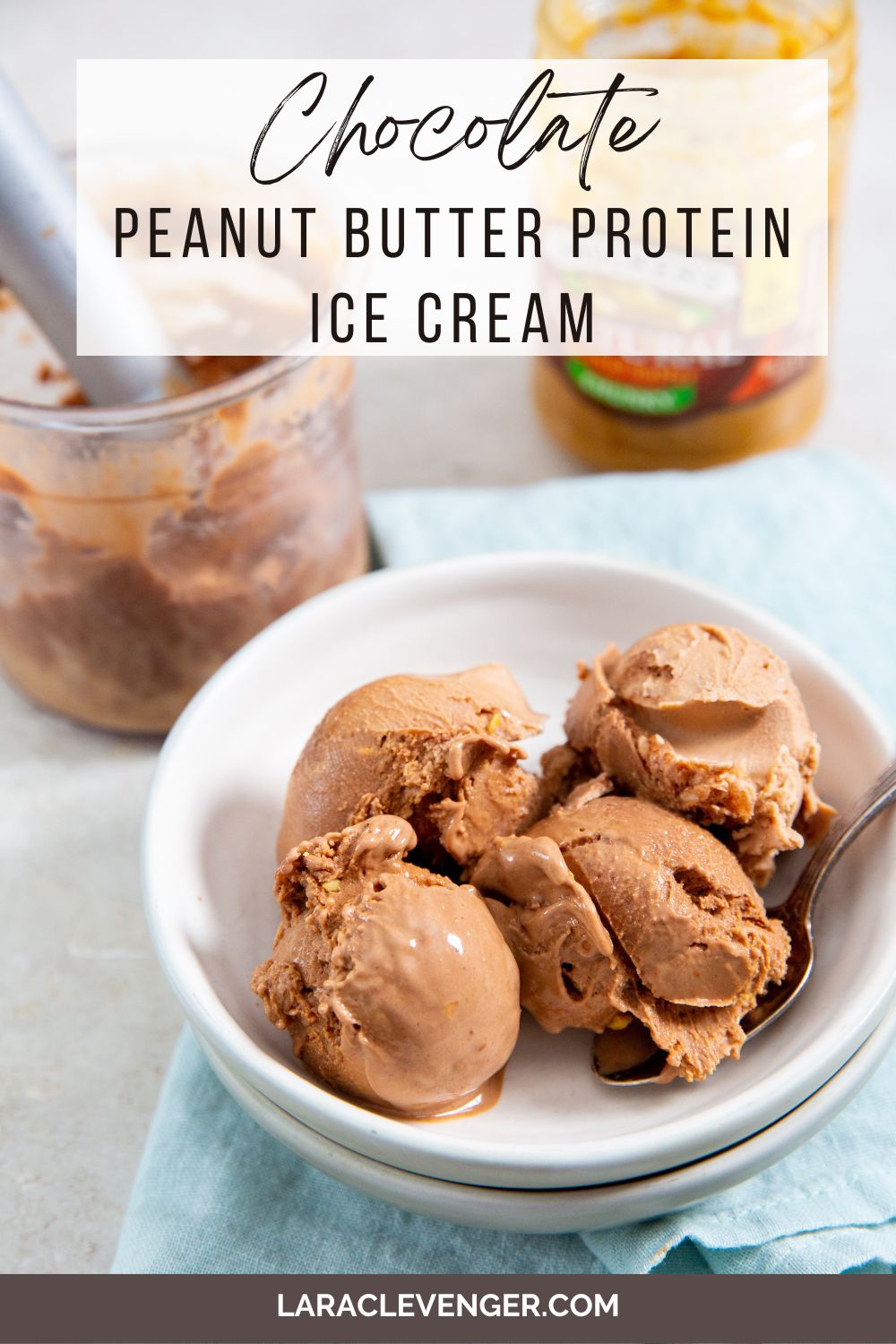 pin of Chocolate Peanut Butter Protein Ice Cream in a white bowl with a spoon in it with a blue napkin on the side