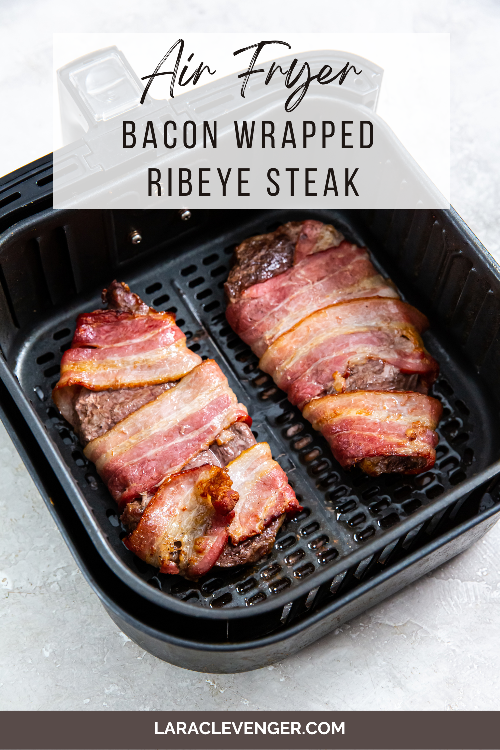 pin of Bacon Wrapped Ribeye Steak in the air fryer basket