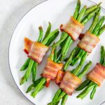 Air fryer Bacon wrapped green beans on a white plate