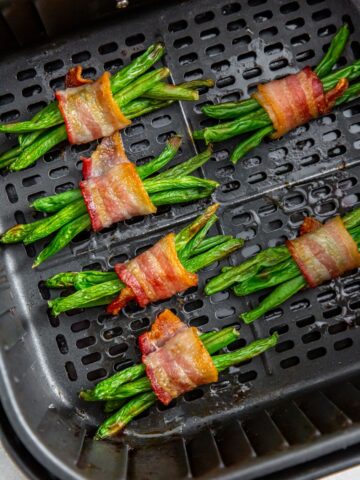 Bacon wrapped green beans in an air fryer basket