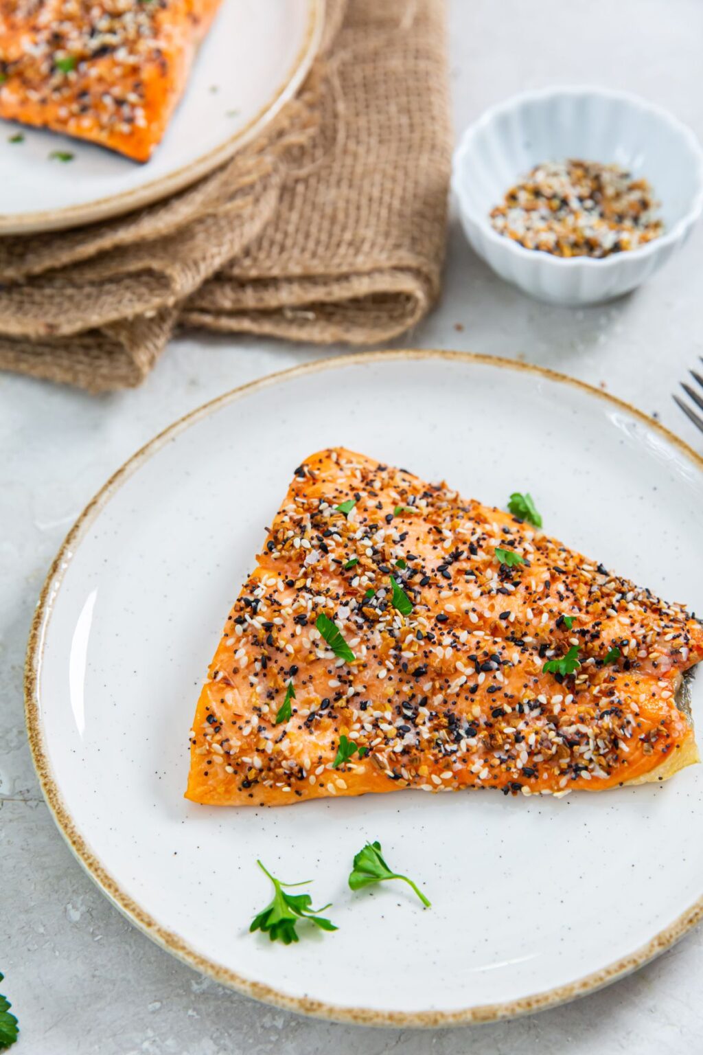 Air Fryer Everything Bagel Salmon with parsley on a white plate.