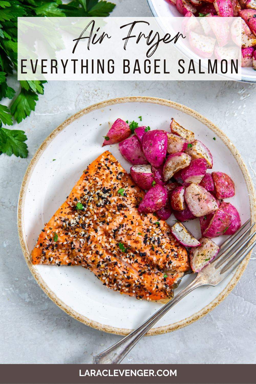 pin of air fryer everything bagel salmon on a white plate with a side of radishes with a fork on the side