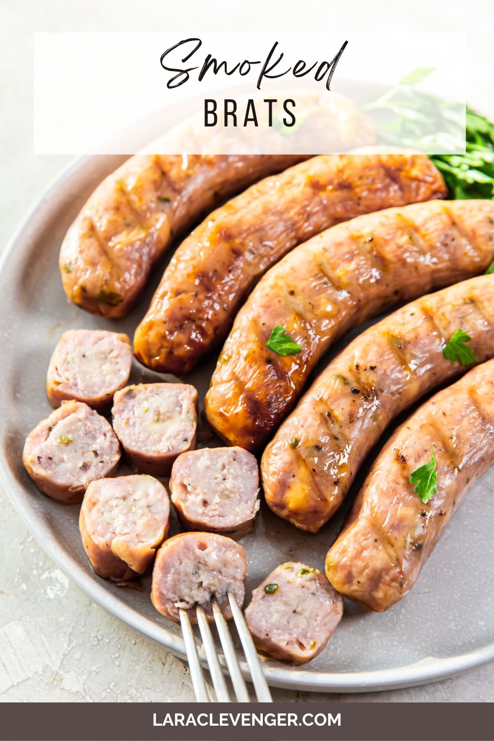 pin of smoked brats on a white plate with a fork