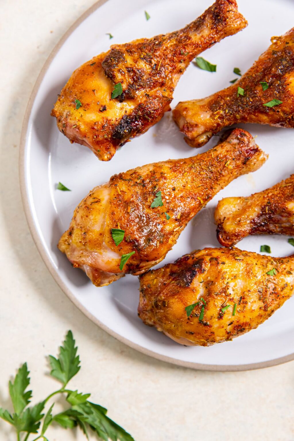 Smoked Chicken Drumstick with parsley on a white plate.
