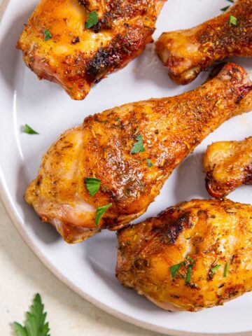 smoked chicken drumsticks on a white plate