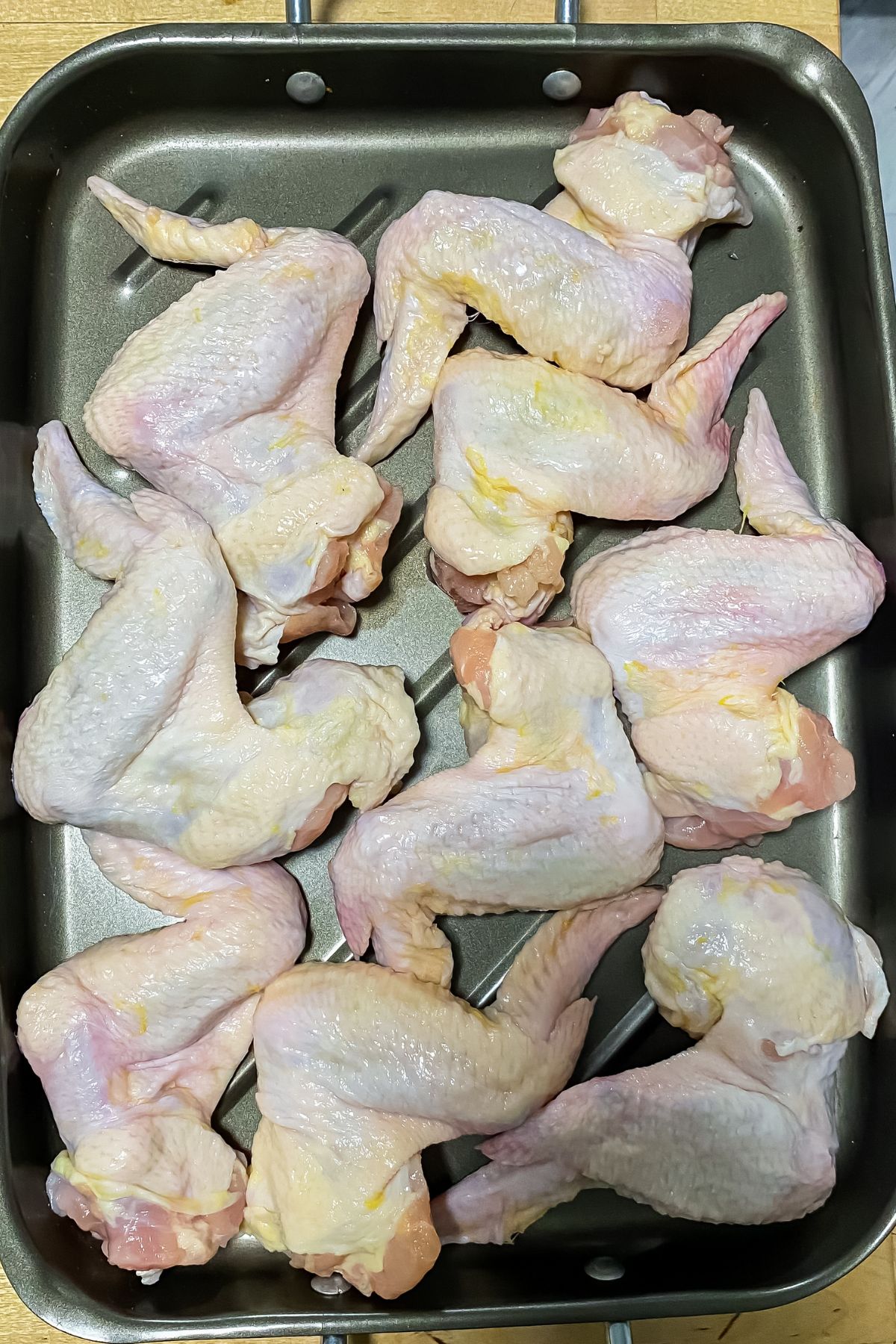 raw chicken wings on a baking sheet