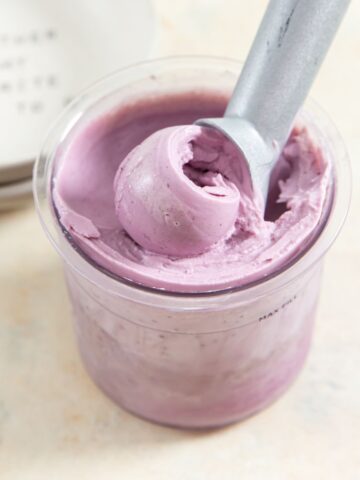 ninja creami blueberry low carb yogurt in a clear pint