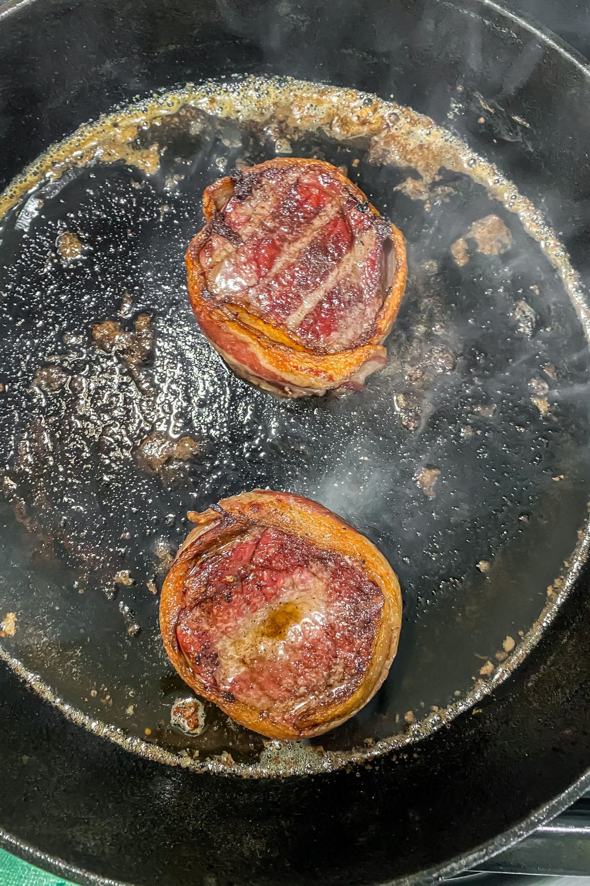 Smoked tender filets are being cooked in a frying pan.