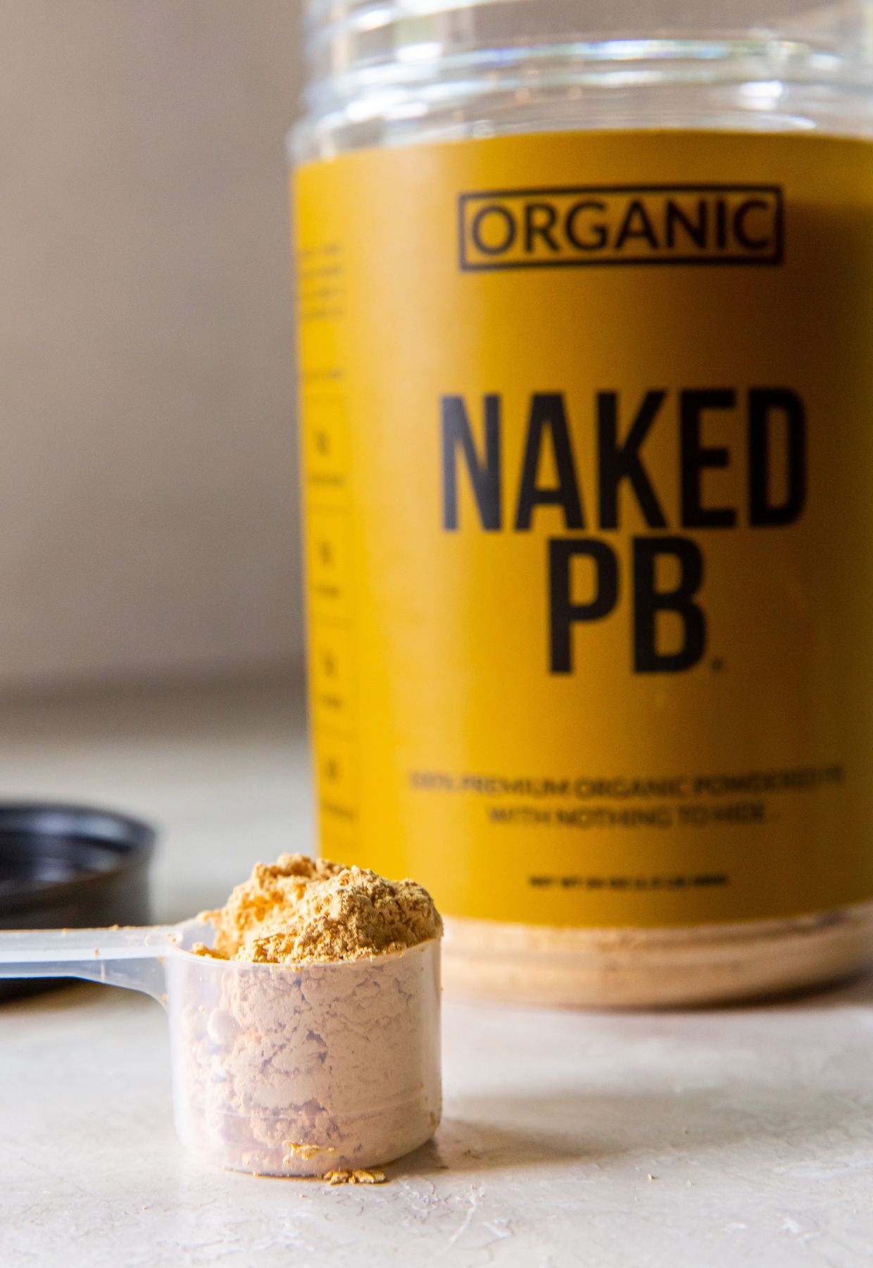 Organic naked pb powder next to a jar.