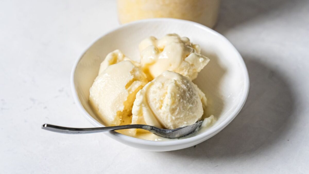 dole whip in a white bowl with a spoon.