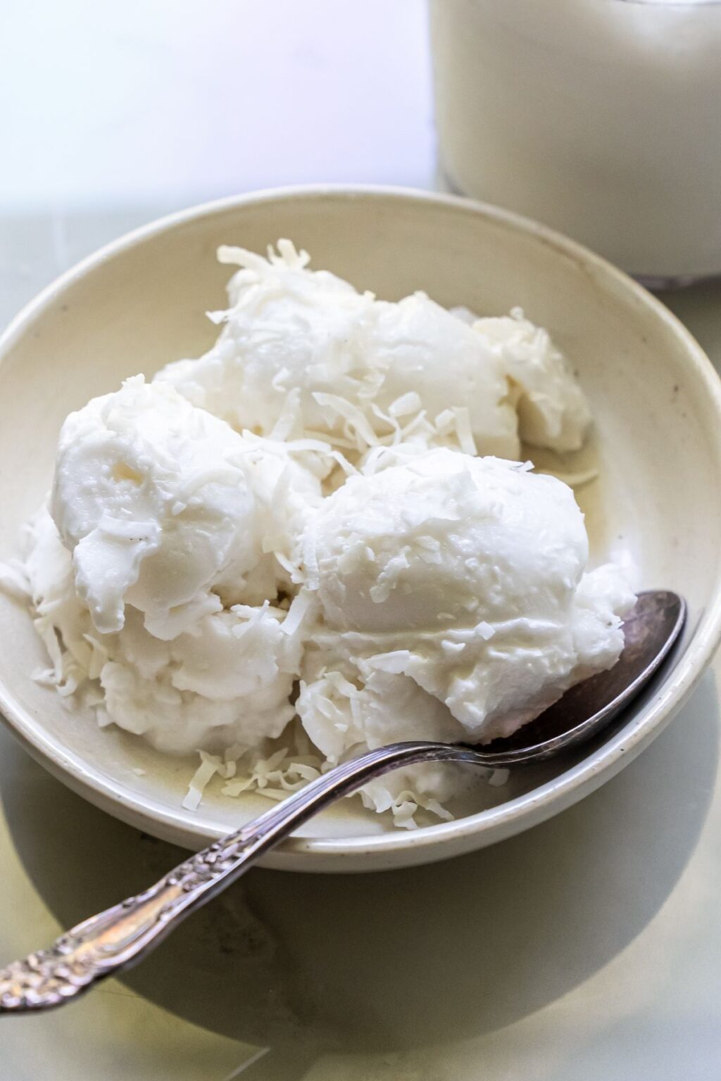coconut ice cream in a bowl with a spoon.