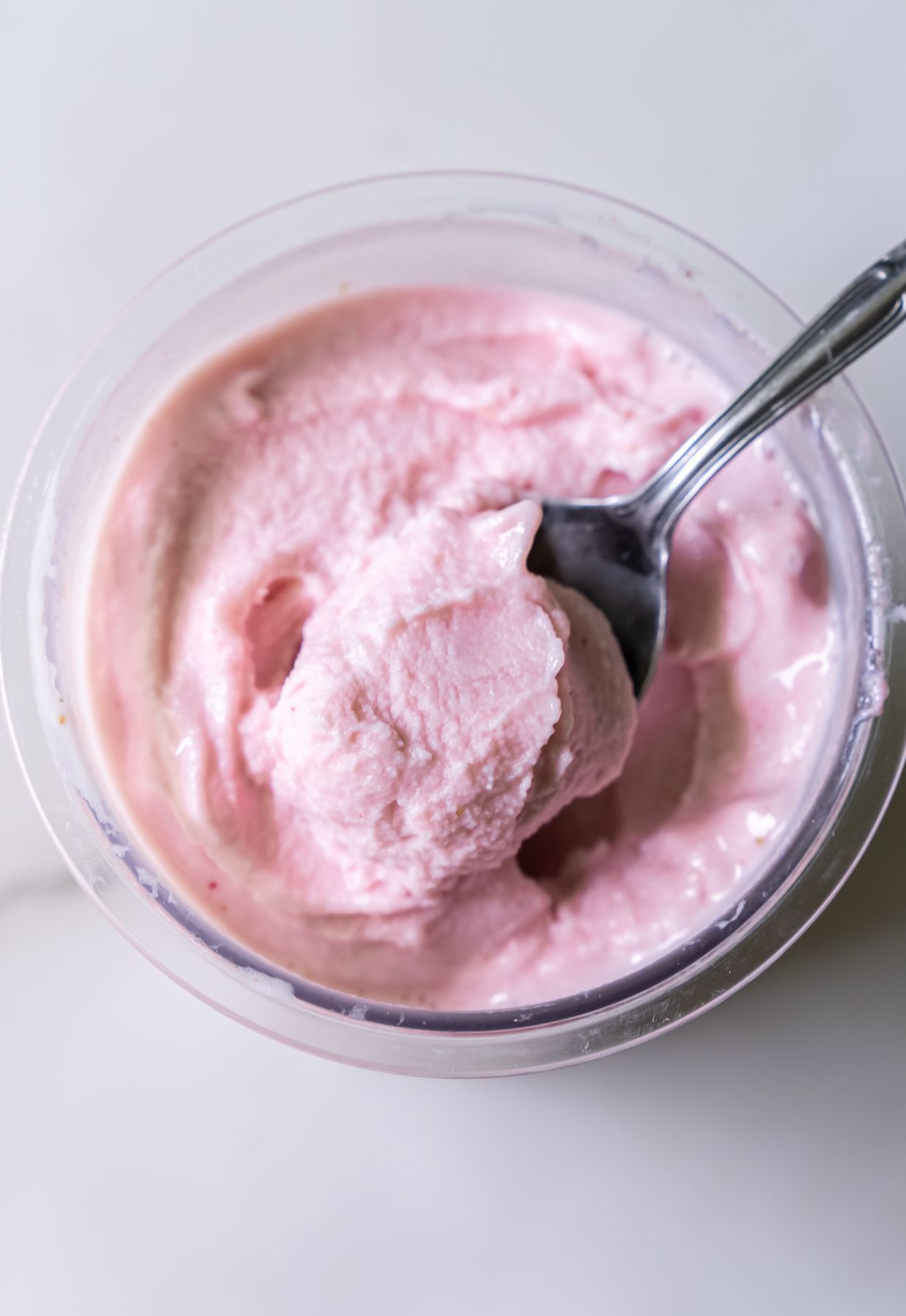 Ninja Creami strawberry ice cream in a pint container with spoon