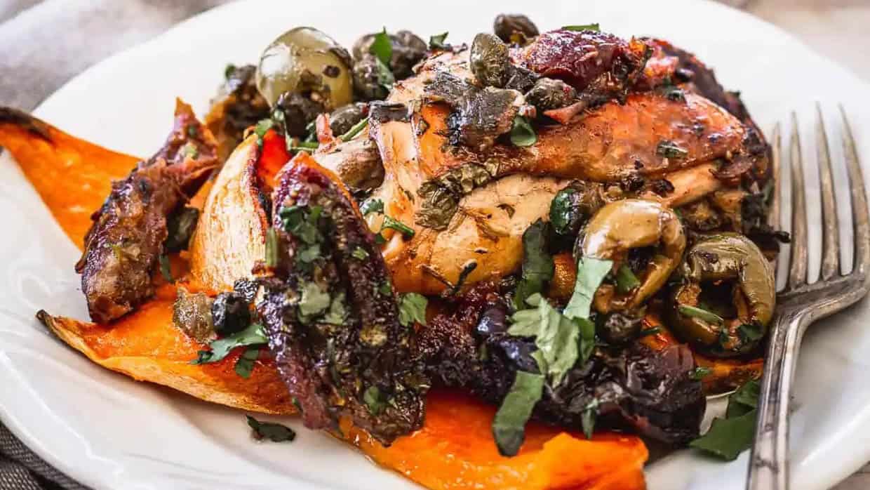 Close up on ottolenghi chicken marbella on plate.