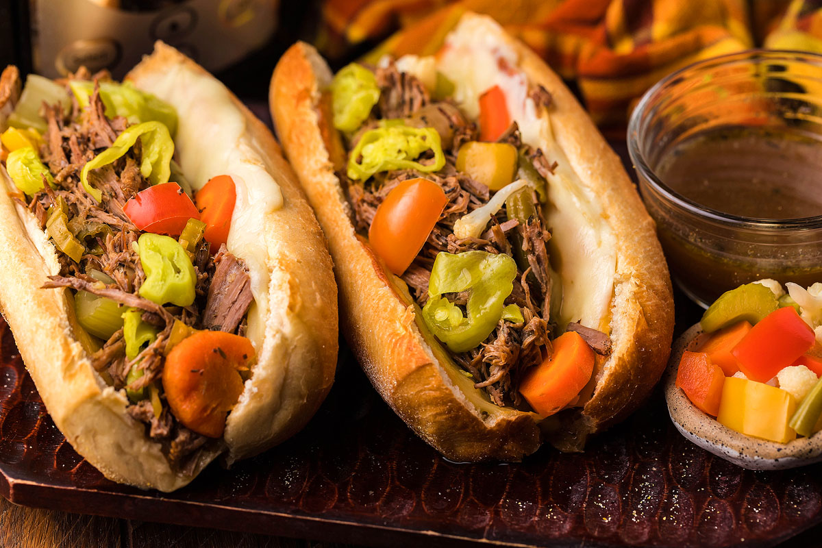 Two buns containing Italian beef.